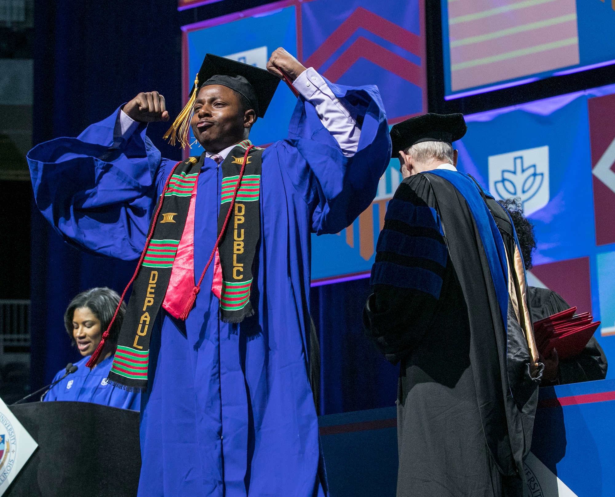 Graduates pose as they receive their diplomas during the commencement ceremony for the Driehaus College of Business at Wintrust Arena in Chicago. (DePaul University/Jamie Moncrief)